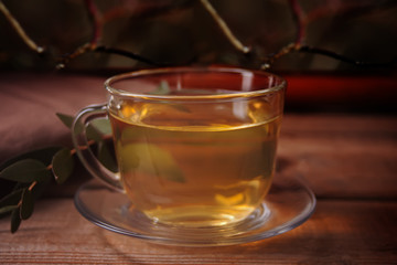 Cup of tea on dark background on the wooden background
