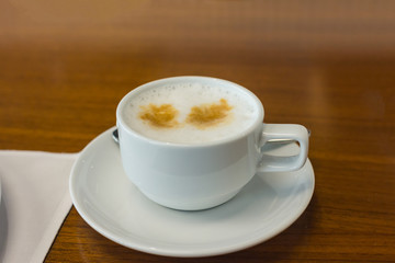 hot coffee cup on wood table in hotel