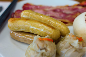  dim sums with sausage on white dish