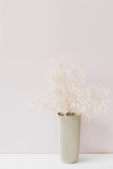 White flowers bouquet on pink background. Minimal floral composition.