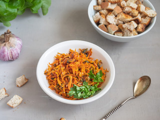 Vegetarian stewed carrot appetizer with garlic and parsley in a deep dish