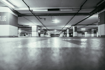 Parking garage in the underground. Asphalt and empty parking lots.