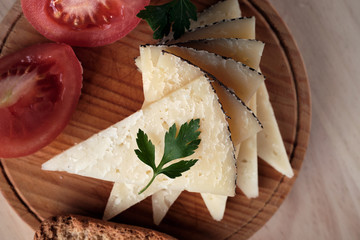 Close-up of sliced ewe's cheese with pieces of tomato