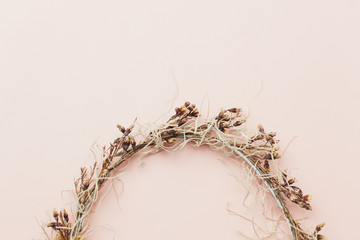 dried wreath of flowers on a pink background (wedding)