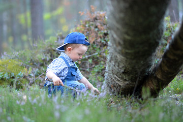 boy sitting near a bench in the park