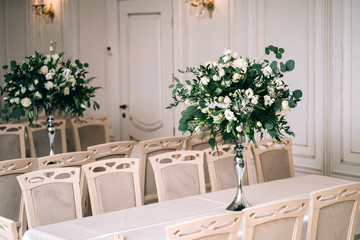 wedding decor, accessories, orchids, roses, eucalyptus, a bouquet in a restaurant, chairs table setting