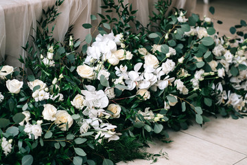 wedding decor, accessories, orchids, roses, eucalyptus, a bouquet in a restaurant, chairs table setting