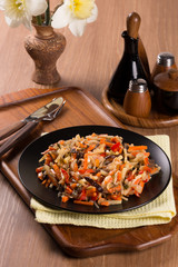 cut vegetables in a black plate on a wooden table