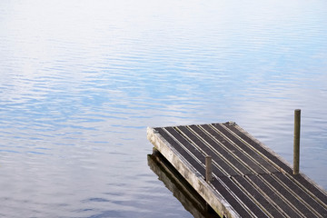 Fototapeta premium Tranquil peaceful water jetty pier at lake