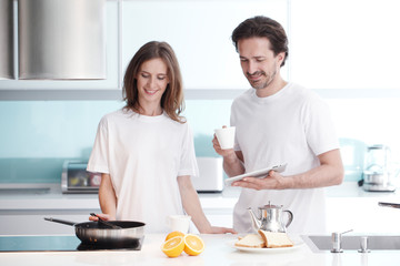 Couple cooking breakfast