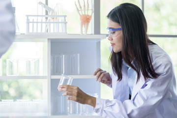 Asian young girl student scientist researching  and learning in a laboratory.