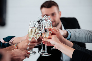 Well done work success young business people toasting each other and smiling while standing in the board room coworking, drink champagne celebrate christmas birthday new year contract
