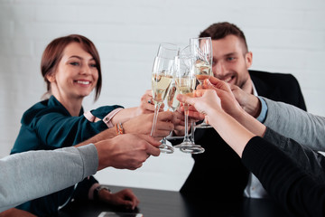 Well done work success young business people toasting each other and smiling while standing in the board room coworking, drink champagne celebrate christmas birthday new year contract