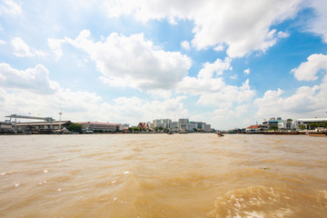 Landcsape and River life of Old vintage community and temple on riverside in Chao Phraya River.