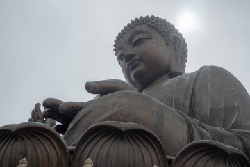 Low angle of Tian tan the great buddha in hongkong on clouds sky background with copy space