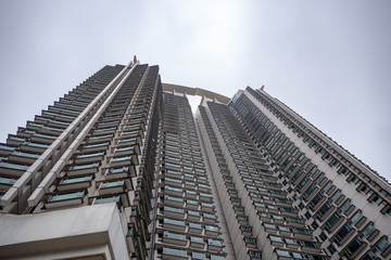 Bottom view of  skyscraper, residential building, on bright sky background