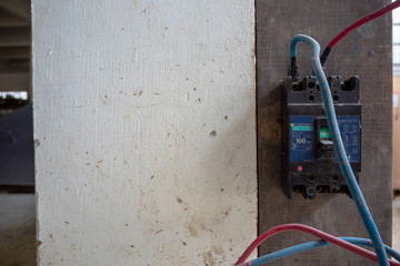 Circuit breaker install on wall with cables connect to machine , copy space
