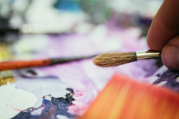 Fototapeta premium Painting artwork: paint brushes on painting background