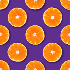 Seamless pattern made of tangerine on a purple background