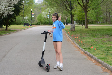 Girl Riding Electric Scooter in Park