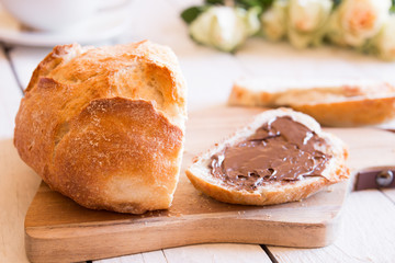 Sliced loaf of wheat bread with peanut butter for breakfast