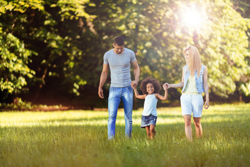 Happy young couple spending time with their daughter