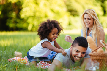 Fototapeta premium Picture of lovely couple with their daughter having picnic
