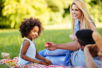 Picture of lovely couple with their daughter having picnic