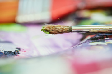 Fototapeta premium Painting artwork: paint brushes on painting background