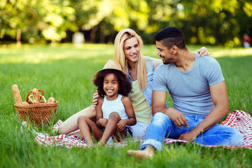 Picture of lovely couple with their daughter having picnic