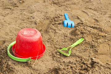 Fototapeta na wymiar abandoned in the sandbox children's toys