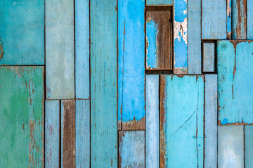 Old wood up into the wall. Vintage wood background with blue color peeling paint.