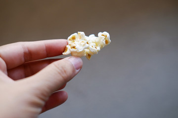 Hand Holding Delicious sweet Popcorn in plastic bags.