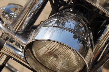Motorcycle. Close-up on its front part: reflector.