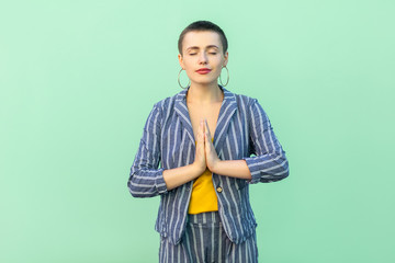 Portrait of calm handsome beautiful short hair young stylish woman in casual striped suit standing...
