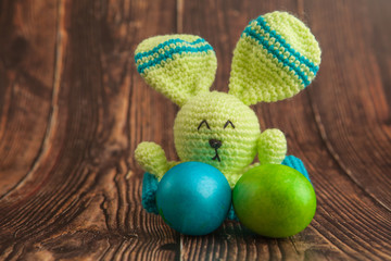 Beautiful colorful easter eggs and bunny toy. Easter concept on wooden background