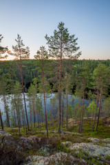 Obraz premium Cliff forest lake landscape in Finland