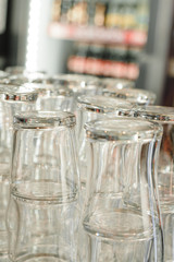 Vertical photo of glasses for drinks and beer. Bar clean glasses. Barman washed glasses