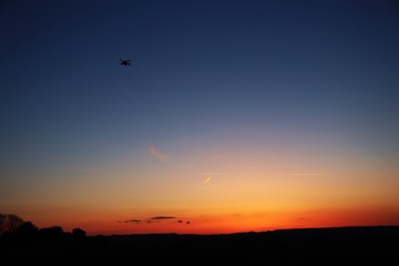 Drone flying into sunset