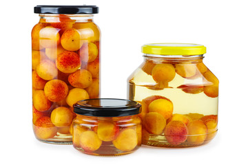 Fototapeta na wymiar Apricots prepared and canned in glass jars isolated on white background