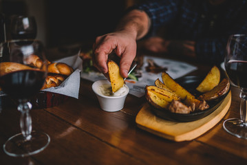 Eating and leisure concept. Enjoying dinner. People having dinner on the table. Assorted delicious vegetables with grilled meat. Toned image. Selective focus.