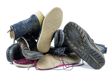 Pile of old boots isolated on the white background