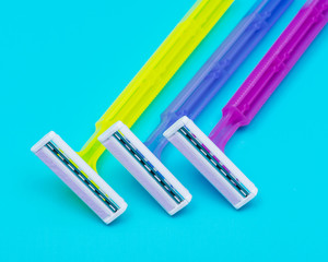 Disposable Women Razors isolated on blue background.