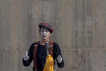 Mime on the street singing with microphone