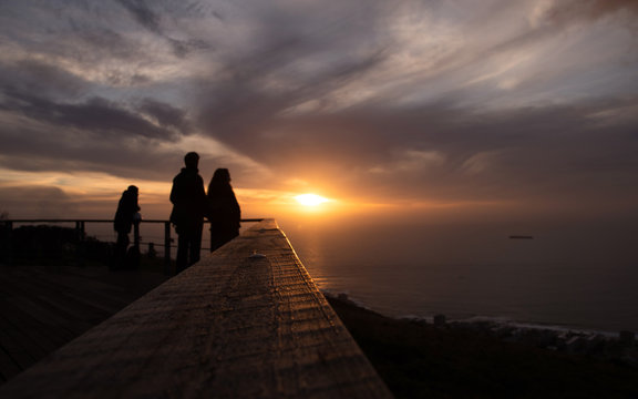 Selective focus  Tourist is taking a picture of sunset at view point . capetown . south africa