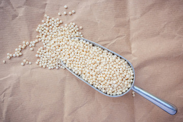 Pearl Israeli couscous (ptitim) in a metal scoop