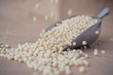 Pearl Israeli couscous (ptitim) in a metal scoop