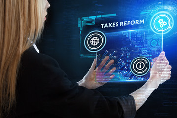 The concept of business, technology, the Internet and the network. A young entrepreneur working on a virtual screen of the future and sees the inscription: taxes reform