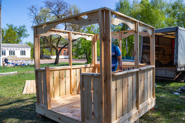Installers build a pavilion of wood material