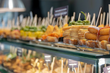 Traditional tapas and pinchos on a counter in a bar in Spain